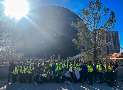 Team in front of sphere day