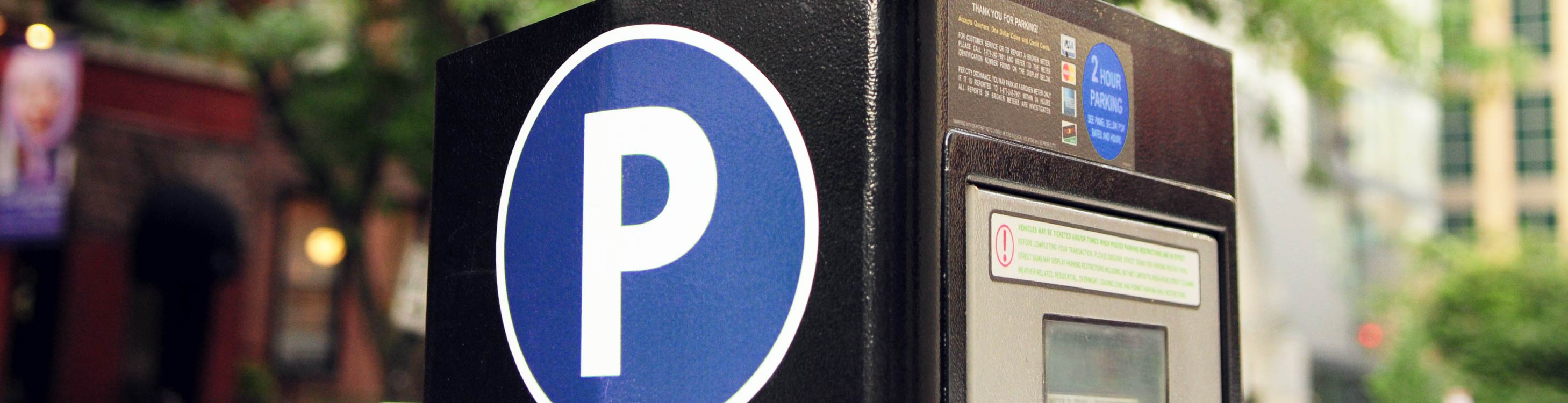 The side of a parking meter on the street.